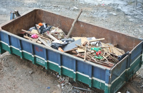 Front view of commercial waste bins and collection vehicle at a business site